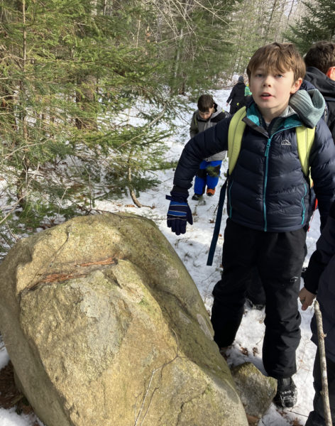 Wiscasset fourth grade student Charlie Herrick checks out a boulder with a missing piece during a field trip to the Hidden Valley Nature Center in Jefferson. (Photo courtesy Becky Hallowell)
