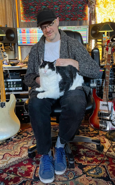 At home in Damariscotta, Stu Mahan confers with a seemingly hard to please member of his fan base, the family cat Tom Jones. (Photo courtesy Stu Mahan)
