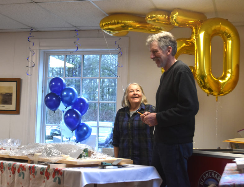 Lisa McSwain and Mike Smith chat by the 250th balloons at Edgecomb's birthday party Sunday, March 17. The event filled the town hall with presentations and neighborly conversation for several hours. "It was great," attendee Ramone Hanley-Warren said. "It's hard to get us Edgombites together because we're all spread out." (Elizabeth Walztoni photo)