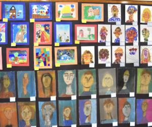 Portraits by RSU 40 elementary and middle schoolers crowd the walls of the district-wide art show at Medomak Valley High School on Thursday, March 14. Responding to the theme of "home," students from the five towns that make up RSU 40 created diverse works that interpreted the theme in a spectrum of perspectives, media, and colors. (Molly Rains photo)