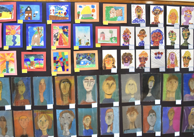 Portraits by RSU 40 elementary and middle schoolers crowd the walls of the district-wide art show at Medomak Valley High School on Thursday, March 14. Responding to the theme of "home," students from the five towns that make up RSU 40 created diverse works that interpreted the theme in a spectrum of perspectives, media, and colors. (Molly Rains photo)