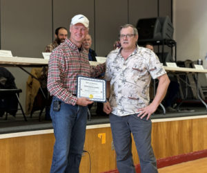 Steven Cowles (left) accepts the Spirit of America Award from Whitefield Select Board Chair Lester Sheaffer Jr. during the annual town meeting on Saturday, March 16. Steven Cowles and his wife, Julie Cowles, received the award for their volunteer work with Whitefield Library and fire department. (Johnathan Riley photo)