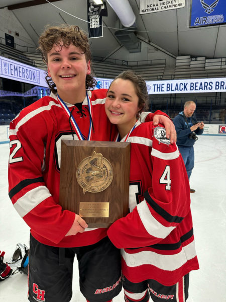 Flynn (left) and Harper Lilly celebrate the Class B North championship won by their Camden Hills Regional High School hockey team. (Courtesy photo)