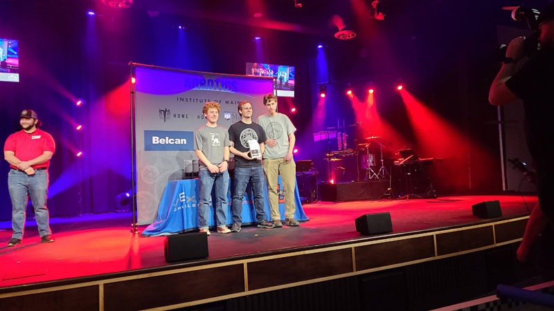 From left: Mica Houghton, Joseph Levesque, and Connor Parson receive their state championship medal as well as the Think Award and second place in the Skills Competition at the VEX Robotics Maine State Tournament on Saturday, March 9. (Photo courtesy Lincoln Academy)