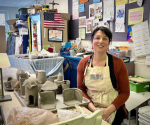 Great Salt Bay Community School art teacher Coreysha Stone sits with recently completed student work in her classroom on Thursday, March 28. Stone was named middle-level art educator of the year by the Maine Art Education Association this year. "I really want people to learn about everything she does," said her nominator, Monique Boutin, of the Chewonki Foundation. (Molly Rains photo)