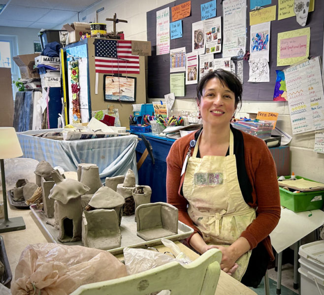 Great Salt Bay Community School art teacher Coreysha Stone sits with recently completed student work in her classroom on Thursday, March 28. Stone was named middle-level art educator of the year by the Maine Art Education Association this year. "I really want people to learn about everything she does," said her nominator, Monique Boutin, of the Chewonki Foundation. (Molly Rains photo)