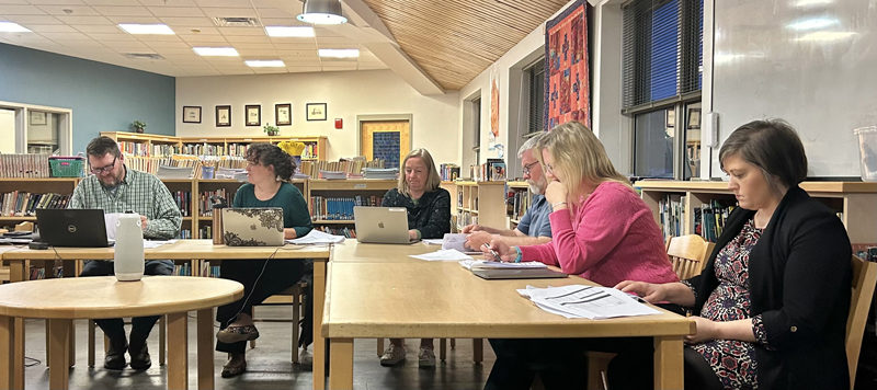 From left: Jefferson School Committee Chair Walter Greene-Morse talks with AOS 93 Superintendent Lynsey Johnston while Assistant Superintendent Tara McKechnie, Jefferson Village School Facilities Director John Carroll, Principal Janet Delmar, and Assistant Principal Laura Mewa study materials at the Jefferson School Committee's Monday, April 1 meeting. (Molly Rains photo)