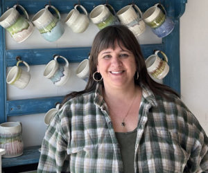 Newcastle potter and art teacher Liz Proffetty stands by her handmade mugs on the morning of Monday, April 15, in her Damariscotta ceramics studio Neighborhood Clay. "Clay is infinitely complicated," Proffetty said. "There is an endless learning curve." (Molly Rains photo)