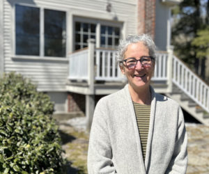 Carrie Levine stands in the sun between her home and clinic in Newcastle. Levine has worked in women's health care in Maine for more than two decades and now operates a small, local practice where she says she feels lucky to get to know her patients and community. (Molly Rains photo)