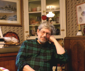 Van Reid at home in Edgecomb, the town he has spent most of his life getting to know. The Moosepath League saga, his series of novels detailing the adventures of a club of gentlemen across late-19th century Maine, drew on his background in a storytelling family and curiosity for history. (Elizabeth Walztoni photo)