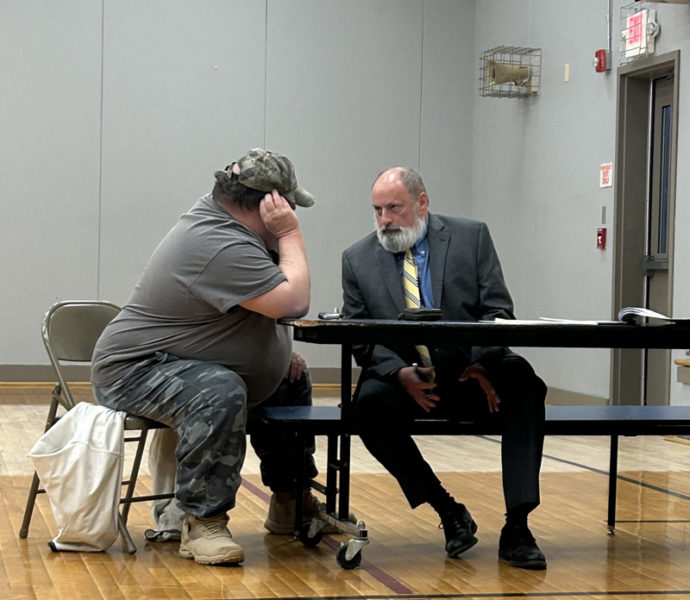 Former Somerville Planning Board Chair John Bergen (left) consults with lawyer John Hamer during his pre-termination hearing on Tuesday, April 9. (Molly Rains photo)