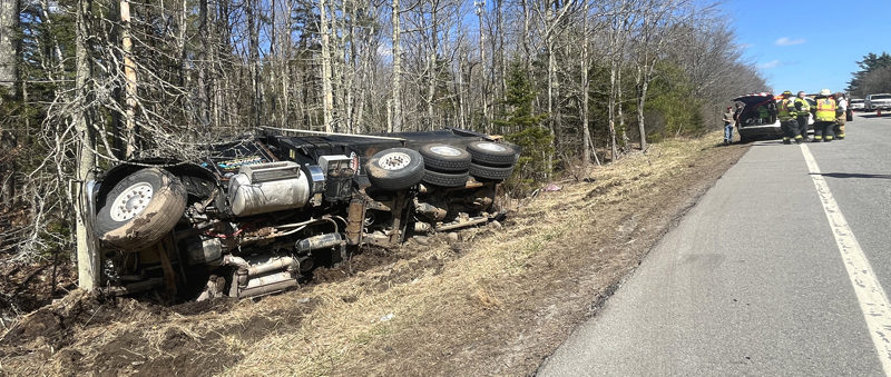 Waldoboro first responders wait for the arrival of wreckers to move a dump truck that flipped onto its side on Route 1 in Waldoboro the afternoon of Sunday, April 14. (Piper Pavelich photo)