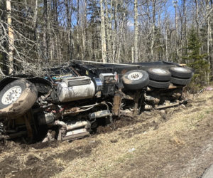 Waldoboro first responders wait for the arrival of wreckers to move a dump truck that flipped onto its side on Route 1 in Waldoboro the afternoon of Sunday, April 14. (Piper Pavelich photo)