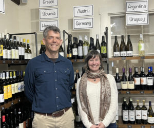 Steven Hufnagel, executive director of Coastal Rivers Conservation Trust, and Sarah Levangie, owner of Beal House, unveil an eco-friendly collaboration. Proceeds from wine sales will support Coastal Rivers' conservation efforts. (Courtesy photo)