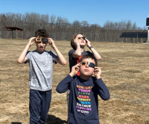 Wiscasset Elementary School students Jace McArdle, Ronan Jewell, and Tyler McLaughlin enjoy the eclipse on Monday, April 8. (Photo courtesy Becky Hallowell)