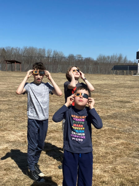 Wiscasset Elementary School students Jace McArdle, Ronan Jewell, and Tyler McLaughlin enjoy the eclipse on Monday, April 8. (Photo courtesy Becky Hallowell)