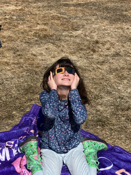 Emelia Underwood takes in the eclipse on Monday, April 8. (Photo courtesy Becky Hallowell)
