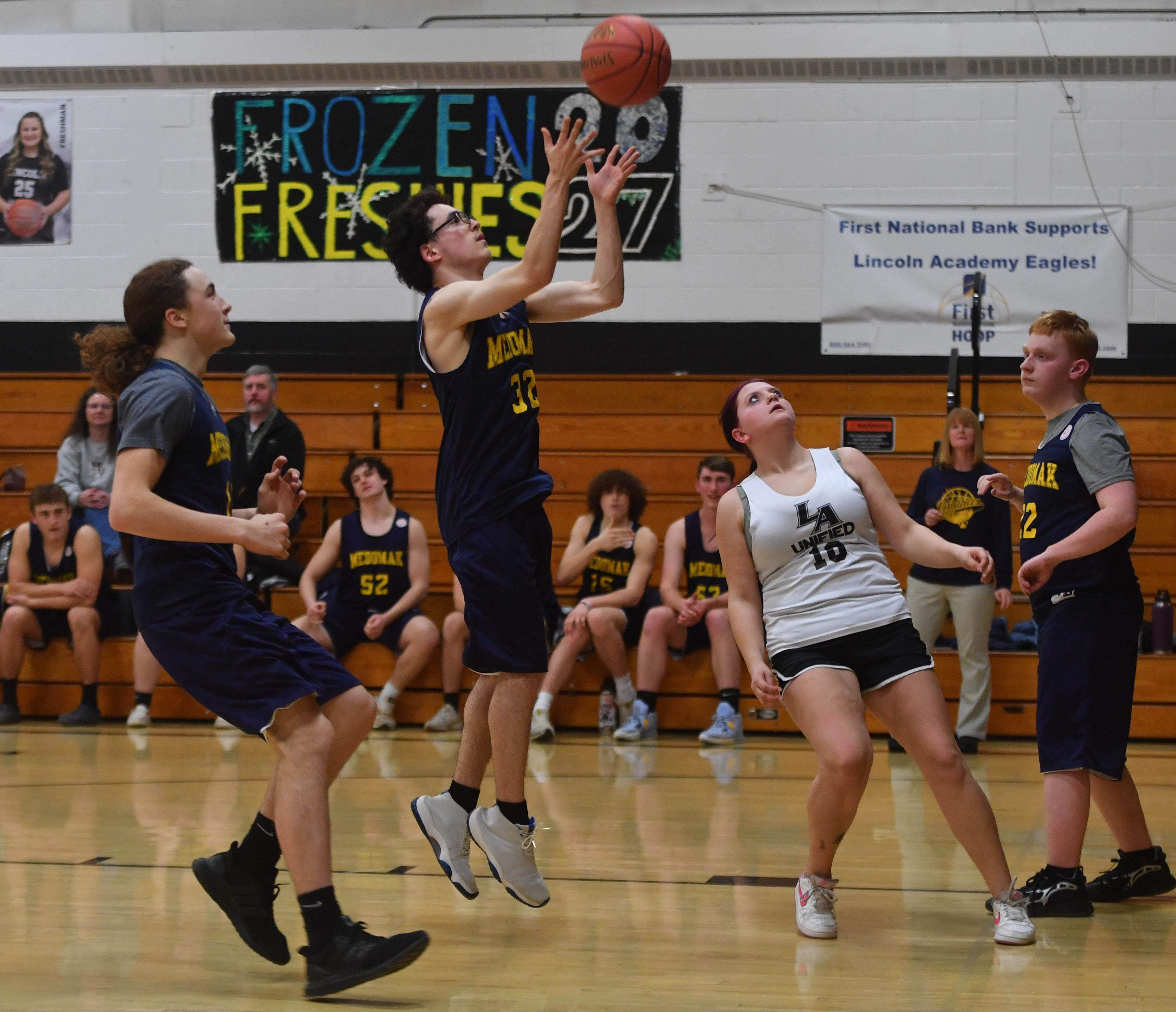 Joey Vargas shoots the ball for the Medomak Valley unified basketball team while Lincoln Academy's Kaylee Sidelinger prepares for a rebound. (Mic LeBel photo)
