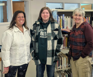 Medomak Valley High School student Teagan Aiken (center) is named the first place winner of the Last Monday of the Month Writing Challenge by judges Norma Hunt (left) and Heather Webster. (Photo courtesy Melissa Barbour)