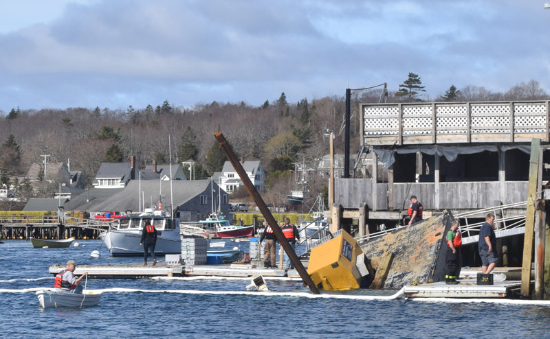 Responders assess a sinking barge by Shaw's Fish and Lobster Wharf in New Harbor the morning of Friday, May 3. (Molly Rains photo)