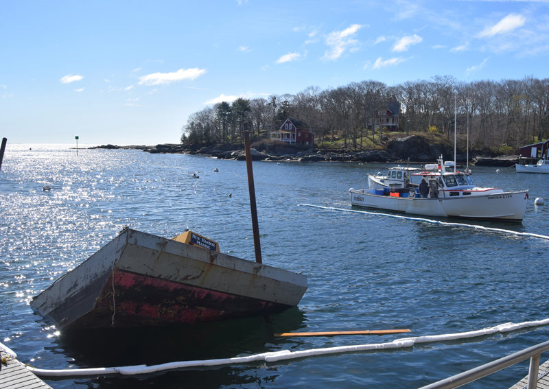 A barge is partially submerged as the tide rises in New Harbor the morning of Friday, May 3. The scene would take more than 13 hours of work from Bristol Fire and Rescue, a salvage team, the U.S. Coast Guard, and Maine Department of Environmental Protection to clear, according to Bristol Fire Chief Scott Sutter Jr. (Molly Rains photo)