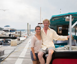 Damariscotta River Cruises co-owners Olga Oros and Chip Holmes pose next to their vessel, the Teciani, one of four boats they have docked at Schooner Landing Restaurant and Marina in August 2023. The couple is celebrating 10years of trips on the Damariscotta River this summer aboard the Teciani. (Courtesy photo)