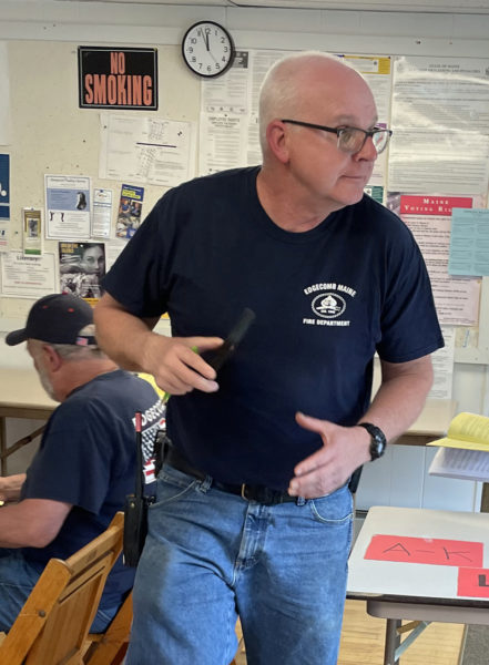 Edgecomb Fire Chief Roy Potter responds to a call about two hours into Edgecomb's annual town meeting Saturday, May 18. Before the call, Potter successfully lobbied the town to adopt a full-time fire chief. (Sherwood Olin photo)