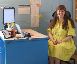 Lincoln Academy English teacher Bridget Wright sits at her desk in her classroom in Newcastle. A teacher, club advisor, dorm parent, and self-proclaimed crafter, Wright said she hopes a lesson her students will carry with them long after they have left Lincoln Academy is to always be open-minded and curious about the world, and to be brave enough to keep trying. (Piper Pavelich photo)