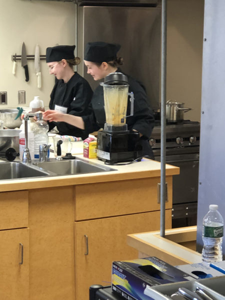 Gwen Weaver (left) and Eleanor Nery compete in the Local Food Challenge at the University of Maines commercial kitchen. The two seniors, who study at both Lincoln Academy and Bath Regional Career and Technical Center, took first place. (Photo courtesy Lincoln Academy)