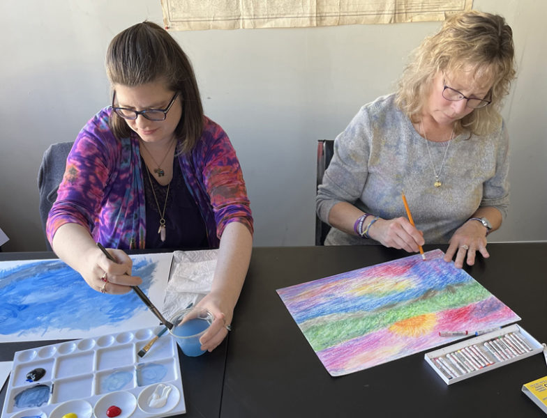 Lauren Woodcock (left) and Sharon Bailey (right) at work during a How Music Helps art workshop held earlier this year at Lincoln County Recovery Community Center. (Photo courtesy Peter Bruun)
