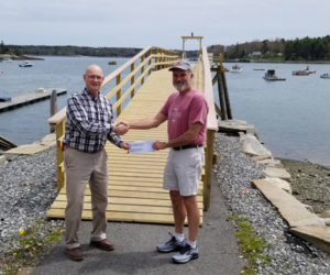 Bill Crider (left) presents B.J. Russell, president of Round Pond Village Improvement Society, with donation. (Photo courtesy Bill Crider)