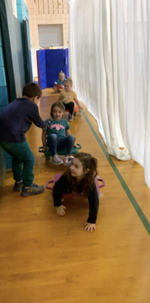 Students roll through a makeshift scooter wash while learning safe scooter skills in physical education class at Nobleboro Central School last week. (Photo courtesy Nobleboro Central School)