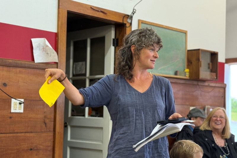 Bremen School Committee Chair Christa Thorpe explains the Great Salt Bay Consolidated School District's administrative reorganization, which Bremen voters approved, at the annual town meeting on Saturday, June 22 at the fire station. (Johnathan Riley photo)