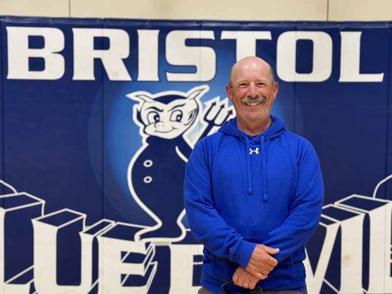 Chris Perry stands in the Bristol Consolidated School gymnasium on May 23. Perry is a decorated wrestler, has taught physical education and coached at the school for 34 years, and also is an award winning pumpkin grower. (Johnathan Riley photo)