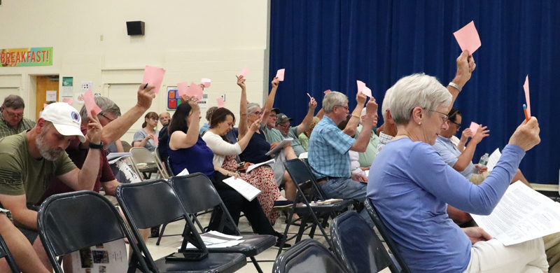 Voters approve an article at Dresden's annual town meeting the evening of Tuesday, June 18 at Dresden Elementary School. Nearly 55 voters attended the meeting and approved every article on the warrant. (Piper Pavelich photo)