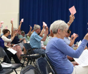 Voters approve an article at Dresden's annual town meeting the evening of Tuesday, June 18 at Dresden Elementary School. Nearly 55 voters attended the meeting and approved every article on the warrant. (Piper Pavelich photo)