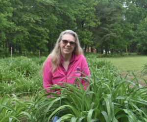 Tina White, of Tina's Daylilies in Jefferson, poses for a photo in one of her daylily gardens. White started selling the perennial flowers 12 years ago and has been hosting an annual fundraiser for multiple sclerosis research for the last decade. (Molly Rains photo)