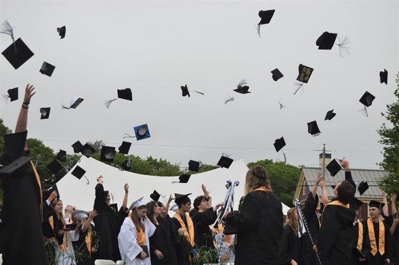 Graduates toss their caps in the air at the end of commencement at Lincoln Academy in Newcastle on Friday, June 7. (Nolan Wilkinson photo)