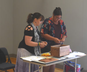 Somerville Treasurer and Tax Collector Sandra Devaney (left) and Town Clerk Samantha Peaslee count votes at Somerville's annual town meeting on the morning of Saturday, June 22. All warrant articles passed during the meeting, which lasted about two hours. (Molly Rains photo)