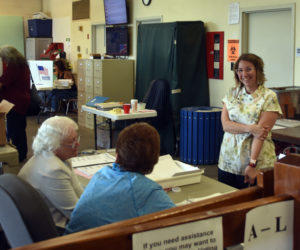 From left: Ballot clerks Delia Mohlie and Wanda Collamore prepare to welcome Waldoboro voters to the polls on June 11 as Town Clerk Pamela Jameson looks on. (Molly Rains photo)