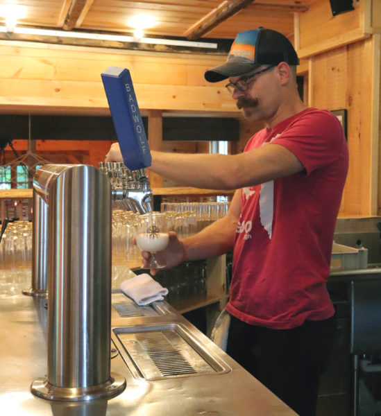 Aekeir Brewing owner Jeremy Meyers pours a beer behind the counter at his taproom at 111 Main St. in Wiscasset the afternoon of Monday, June 17. Meyers opened the taproom to the public on June 5. (Piper Pavelich photo)