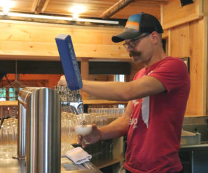 Aekeir Brewing owner Jeremy Meyers pours a beer behind the counter at his taproom at 111 Main St. in Wiscasset the afternoon of Monday, June 17. Meyers opened the taproom to the public on June 5. (Piper Pavelich photo)