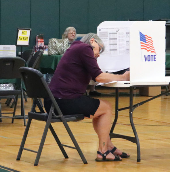 A Wiscasset voter casts their ballot during the town's annual meeting by referendum and state primary election on Tuesday, June 11. Polls were open from 8 a.m. to 8 p.m. at the Wiscasset Community Center. (Piper Pavelich photo)