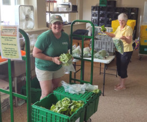 Healthy Lincoln County staff member Michaela Stone and volunteer Diane Newcomb process donated veggies for share tables. (Photo courtesy Leifa Gordon)