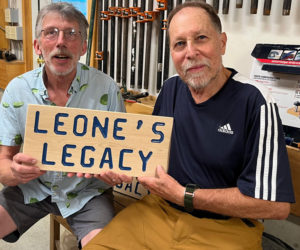 Mike Smith, former Edgecomb select board chair and past advisory board member, presented the trail sign to former advisory board chair Bob Leone at a pot luck cookout for the board. (Courtesy photo)