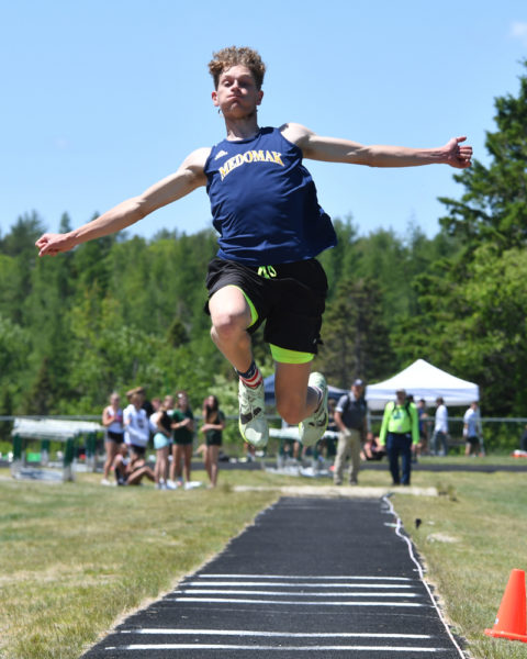 Will Rush, of Medomak Valley, soars to a first place finish in the triple jump at the Class B state championship. (Mic LeBel photo)