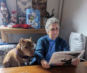 Tim reads his weekly copy of The Lincoln County News with help from Grammy Sally Smith. (Erik Brobst photo)