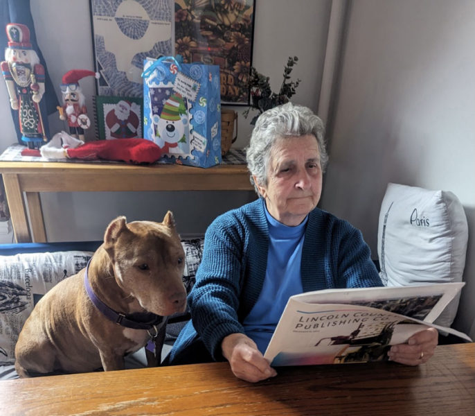 Tim reads his weekly copy of The Lincoln County News with help from Grammy Sally Smith. (Erik Brobst photo)