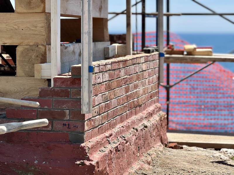 The first bricks laid in the rebuilding of the walls of the bell house in Pemaquid Point Lighthouse Park in Bristol on Thursday, June 27. According to Bristol Parks Director Shelley Gallagher, the bell house should be completed by the end of July or the beginning of August. (Johnathan Riley photo)