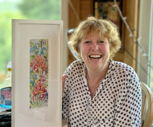 Actress, artist, educator, cook, baker, and lifeguard Deb Arter holds one of her paintings in her Damariscotta home. Arter has been teaching adult education classes about art and cooking for the past 12 years. (Johnathan Riley photo)
